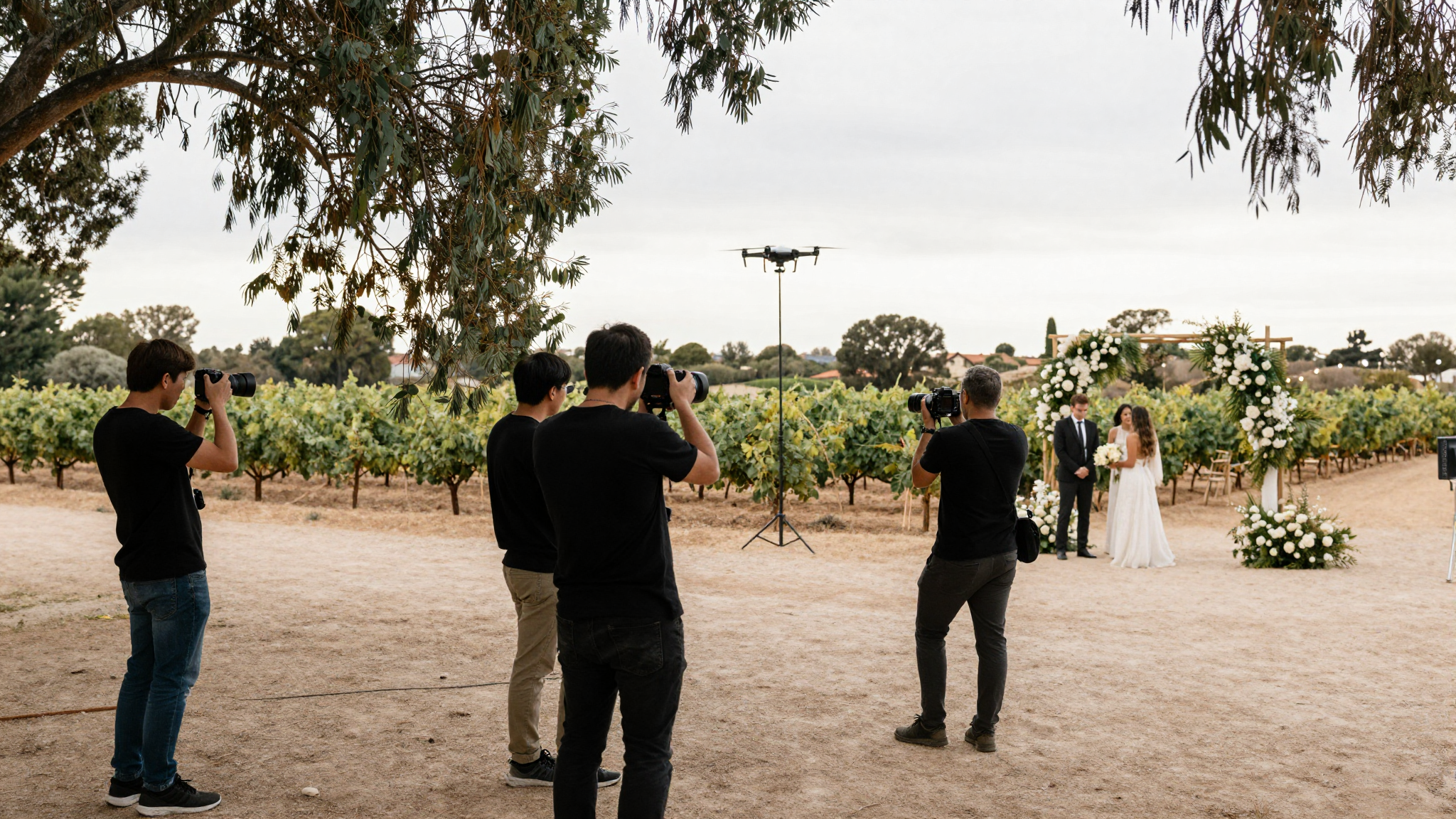 A tier-3 wedding photography setup at a Stellenbosch wine farm — primary shooter and second-shooter coordinating during the ceremony.